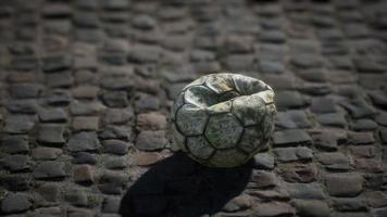 bola de futebol velha no pátio do pavimento video