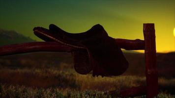 old saddle as the sunset in the country video