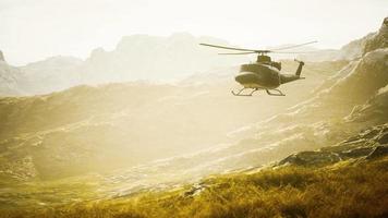 slow motion Vietnam War era helicopter in mountains video