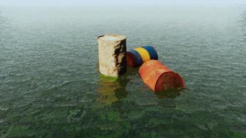 old rusty barrels oil in sea water illustrates the pollution of environment video