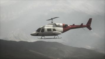 extreme slow motion flying helicopter near mountains with fog video