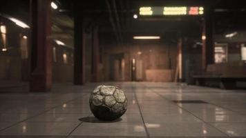 old soccer ball in empty subway video