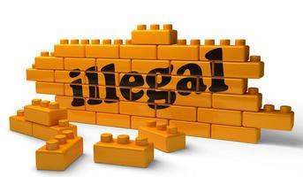 illegal word on yellow brick wall photo
