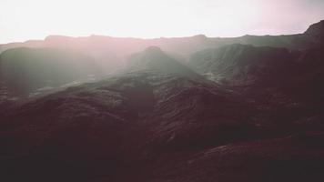 dark atmospheric landscape with high black mountain top in fog video