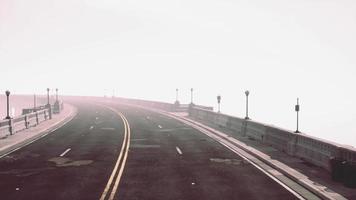 Asphalt highway and mountain in deep fog video