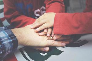 hands of a father with his children photo