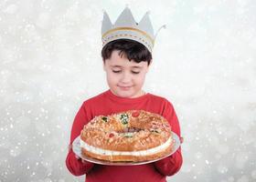 Happy child with King cake or Roscon de Reyes photo