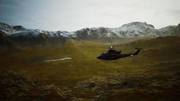 slow motion Vietnam War era helicopter in mountains video