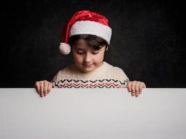 happy child in christmas next to a poster photo