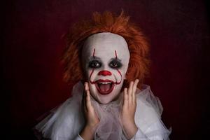 smiling boy dressed as a clown photo