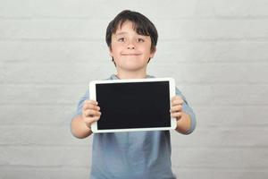 Happy child holding a tablet photo