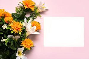 Happy Mother's Day.Bouquet of yellow flowers and white paper with copy space background photo