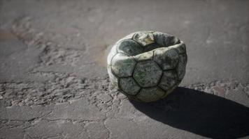 Old soccer ball the cement floor video