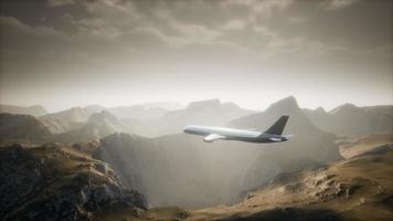 Passenger aircraft over mountain landscape video