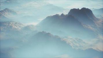 Distant mountain range and thin layer of fog on the valleys video