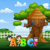 Happy kids holding ABC text in the park vector