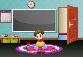 A little boy reading book in the classroom vector