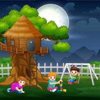 Happy kids playing around tree house at night vector