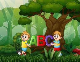 Cartoon two boys holding ABC text on the nature vector