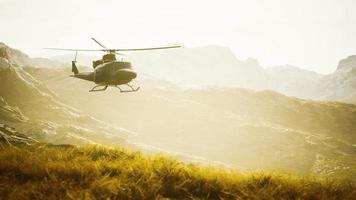 slow motion Vietnam War era helicopter in mountains video