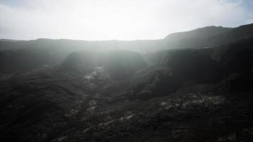 dark atmospheric landscape with high black mountain top in fog video