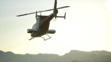 extreme slow motion flying helicopter and sunset sky video