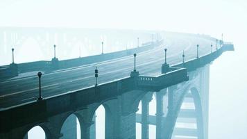 illuminated empty road bridge in a fog video