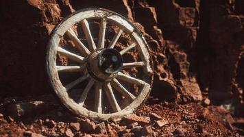 old wooden cart wheel on stone rocks video