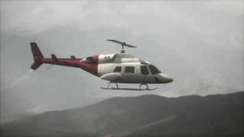 extreme slow motion flying helicopter near mountains with fog video