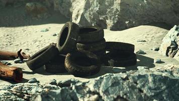 Old tire on the seashore and pollution of nature video