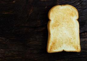 toast bread slice isolated on wood background photo