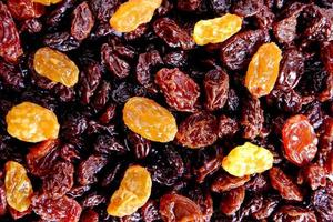 Yellow and black raisins seamless background photo