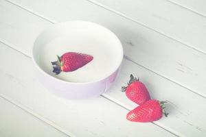 strawberries on wooden table photo