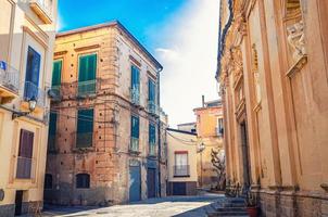 Typical italian narrow street of Tropea town historical centre with old buildings photo