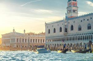 Venice cityscape with gondolas and yacht boats on water of San Marco basin photo