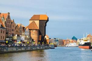 Zuraw Crane and colorful buildings on Motlawa river, Gdansk, Poland photo