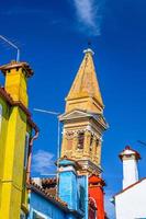 techos de casas coloridas con paredes multicolores y campanario de la iglesia de san martino en burano foto