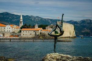 Statue Ballerina in front of stone citadel fortress, old town, medieval buildings, red tiled roofs, chapel of Saint Ivan church photo