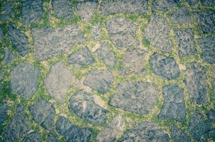 Cobblestone pavement background with copy space. Abstract old close-up cobble stone texture photo