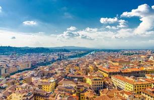 Top aerial panoramic view of Florence city historical centre, bridges over Arno river photo