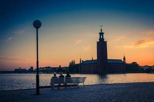 Silhouette of women sitting on bench, Stockholm City Hall, Sweden photo