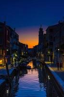 Venice cityscape with narrow water canal, fondamenta embankment photo