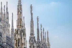 White marble statues on roof of Duomo di Milano Cathedral, Italy photo
