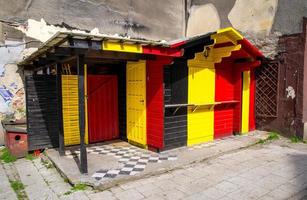 Wooden building with Belgium and Germany flag colors photo