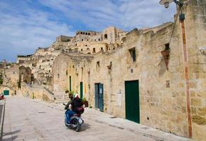 Motorcyclists in helmets riding a motorcycle on streets, Matera, Italy