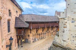Courtyard of medieval Loket Castle Hrad Loket gothic style building on massive rock with stone walls