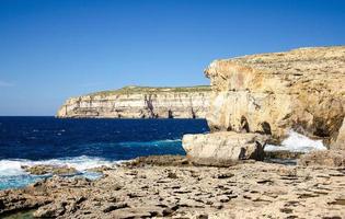 Rocky coastline cliffs near collapsed Azure window, Gozo island, Malta photo