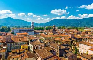 Aerial top panoramic view of historical centre medieval town Lucca with old buildings, typical orange terracotta tiled roofs photo