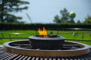 The Olympic Flame in Olympic Park in Lausanne, on the shore of the Lake Leman photo