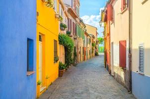 Rimini, Italy Typical italian cobblestone street with colorful buildings photo